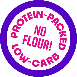 Circular badge with purple border and white center stating 'Protein-Packed Low-Carb No Flour!' in bold pink text.