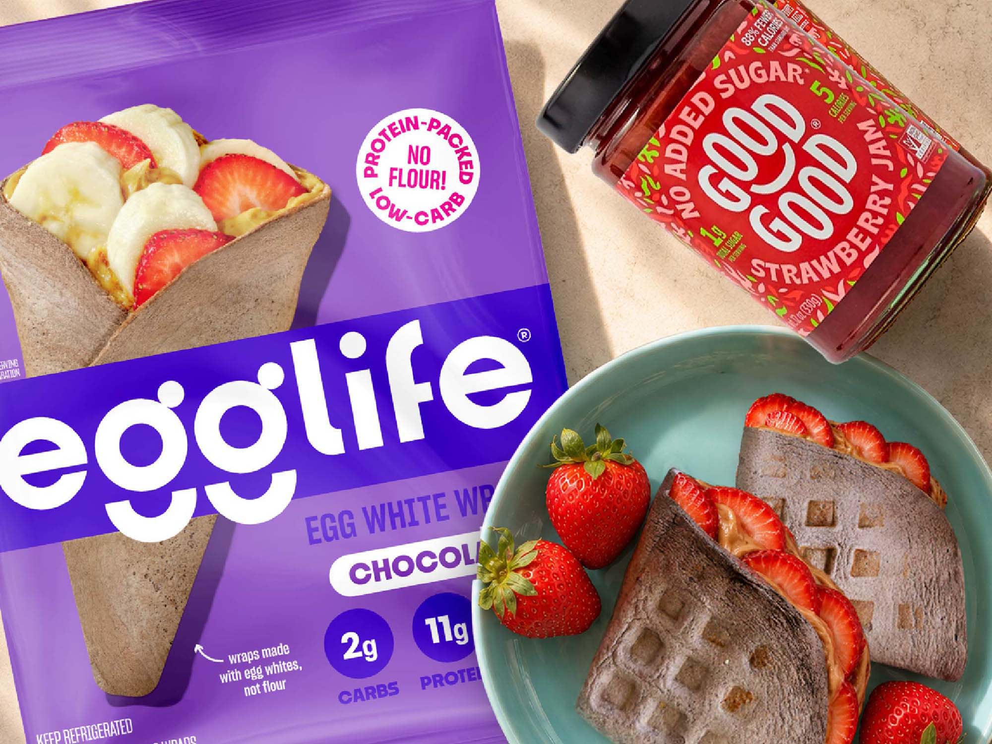 Strawberry chocolate waffle sandwich made with an egglife Chocolate wrap, protein cream cheese, GOOD GOOD strawberry jam and fresh strawberries.