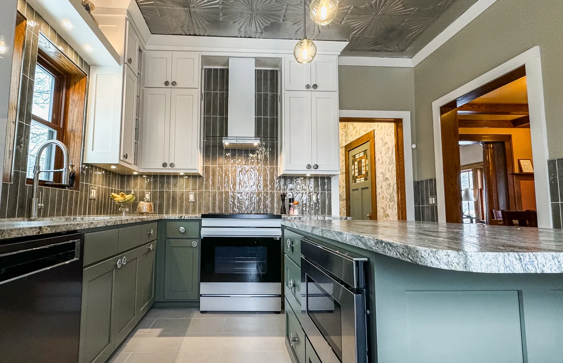 kitchen remodel with white and teal cabinets, and a dark grey backsplash
