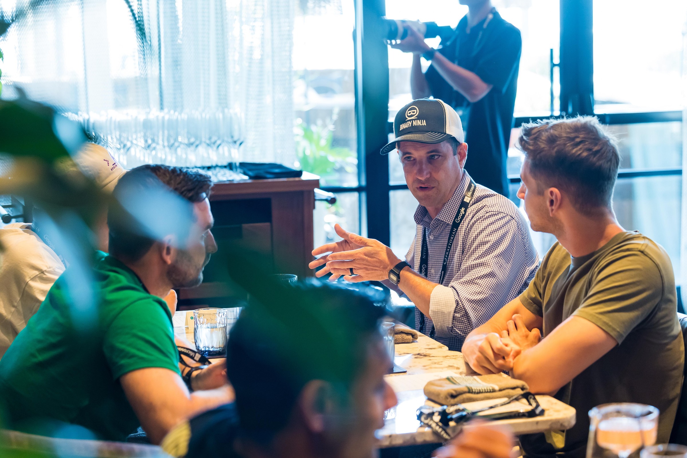 An attendee gesturing during a lively discussion over dinner.