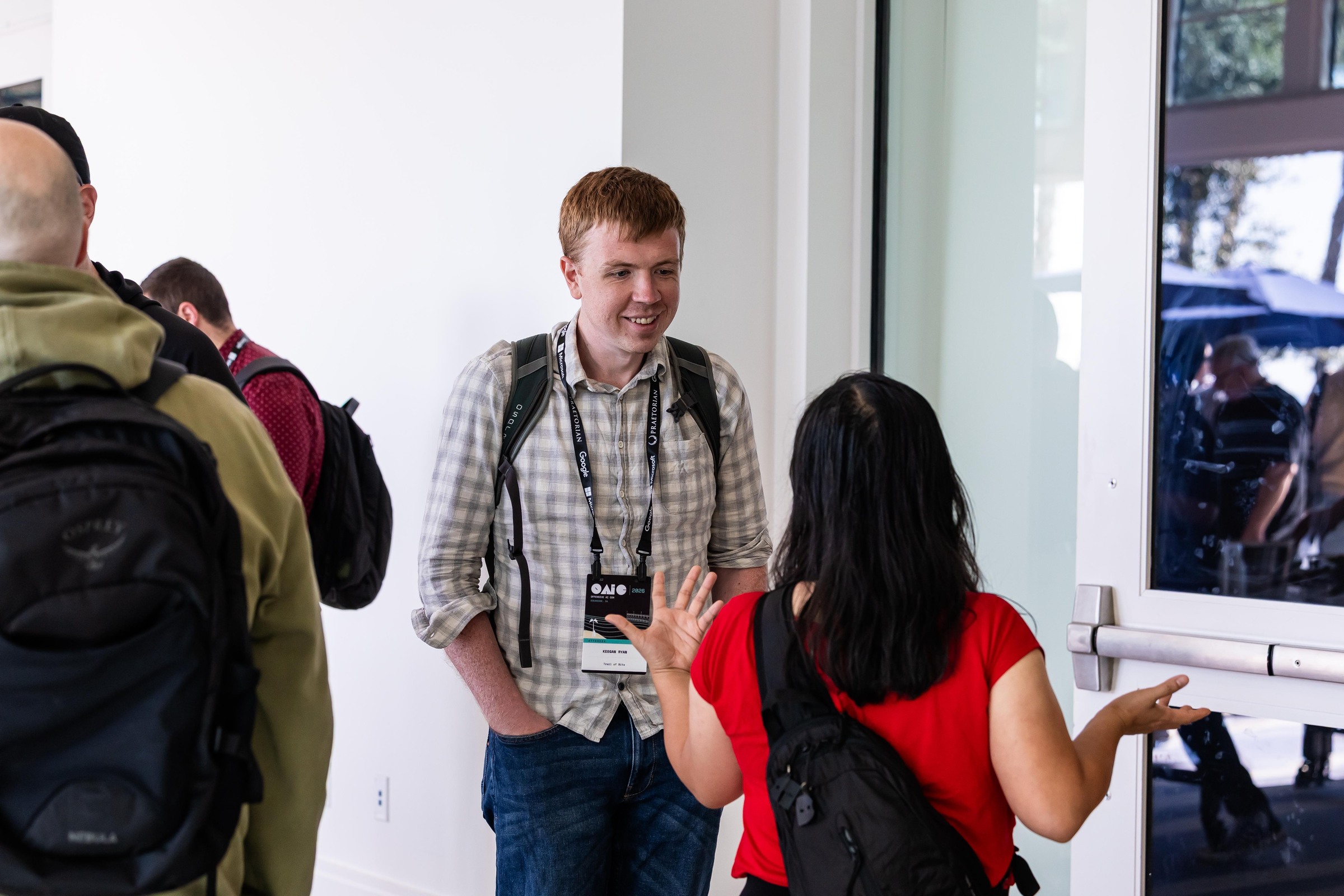 Two attendees exchanging ideas in the conference foyer.