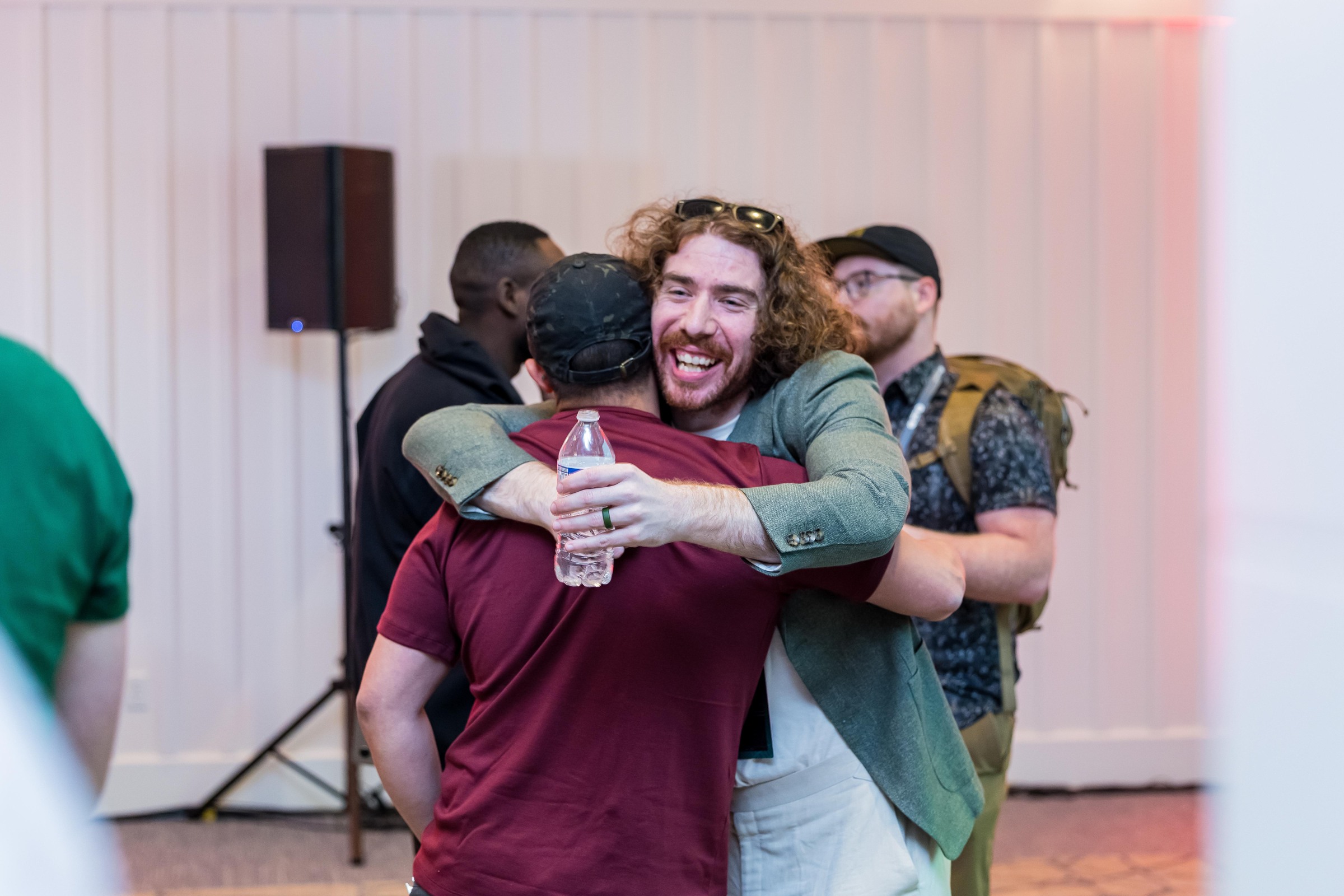 Attendees sharing a smiling greeting after a research session.