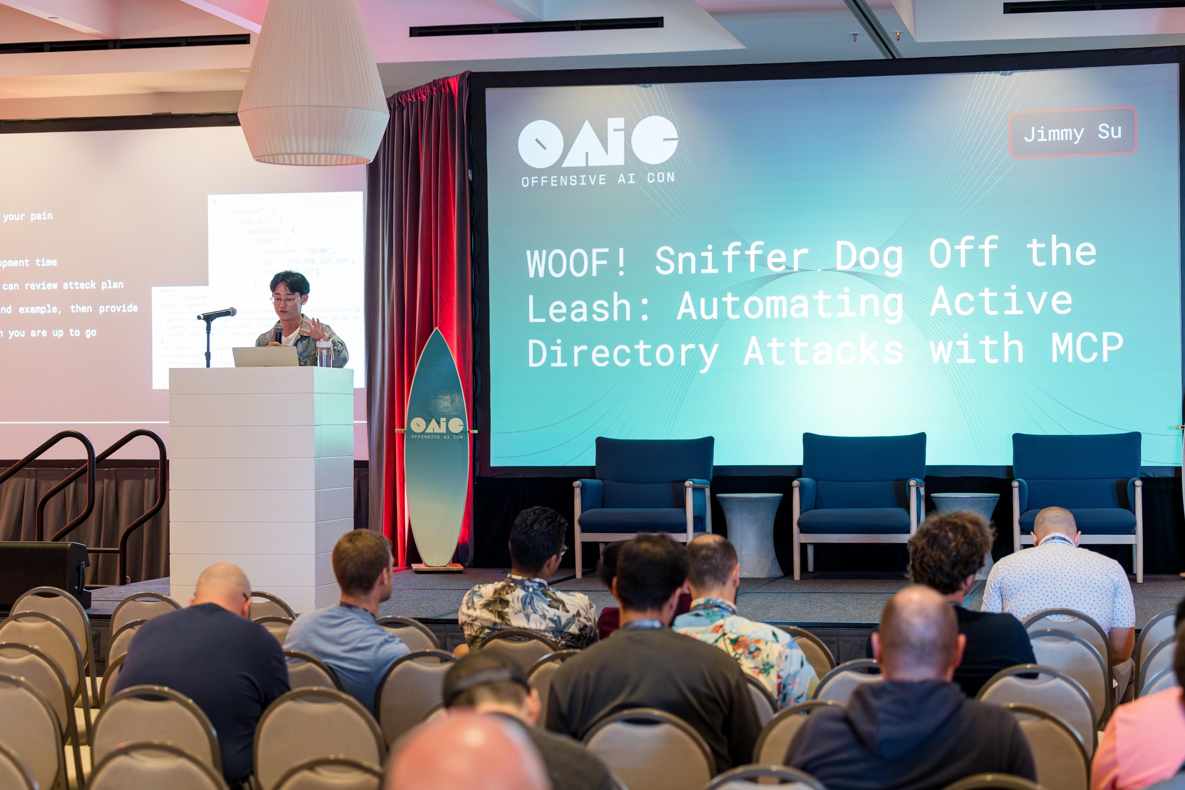 A researcher presenting WOOF! Sniffer Dog Off the Leash with the talk title projected behind.