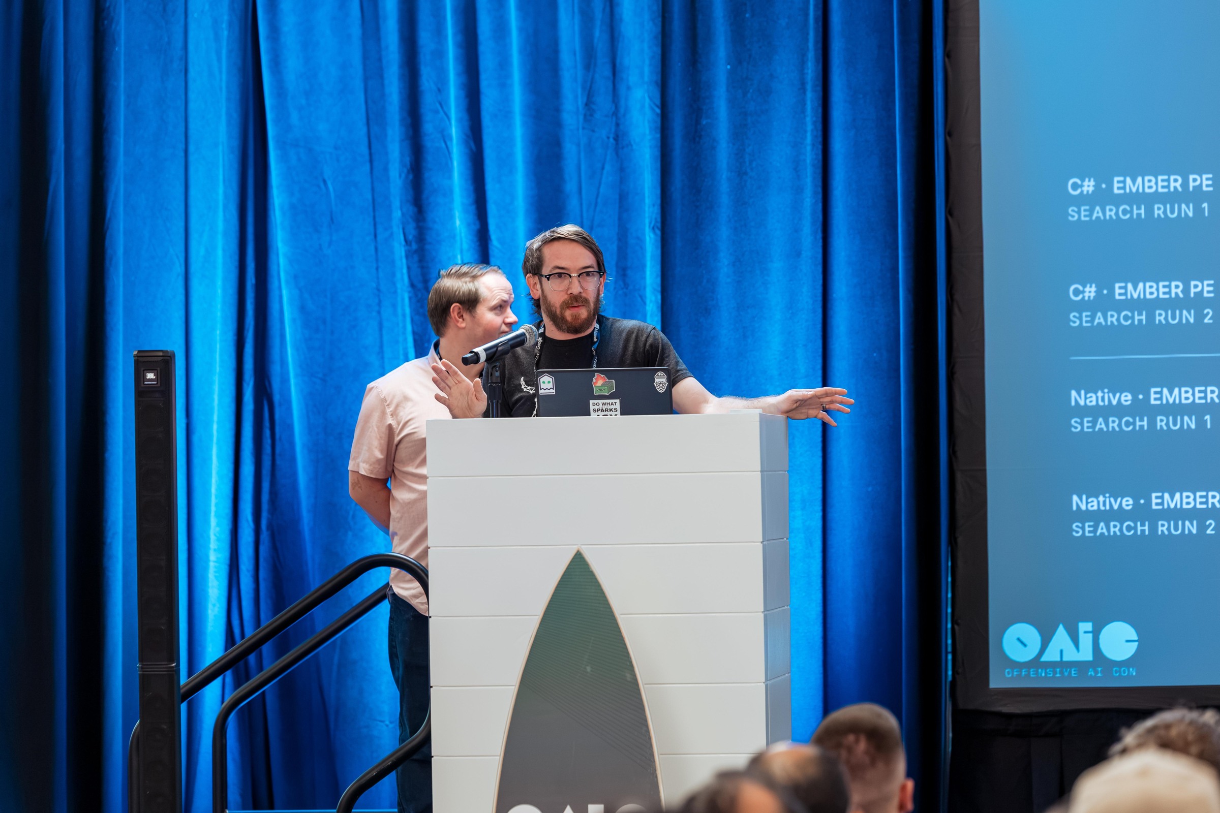 Two researchers at the lectern, one pointing to a technical slide during Your EDR Has Boundary Issues.