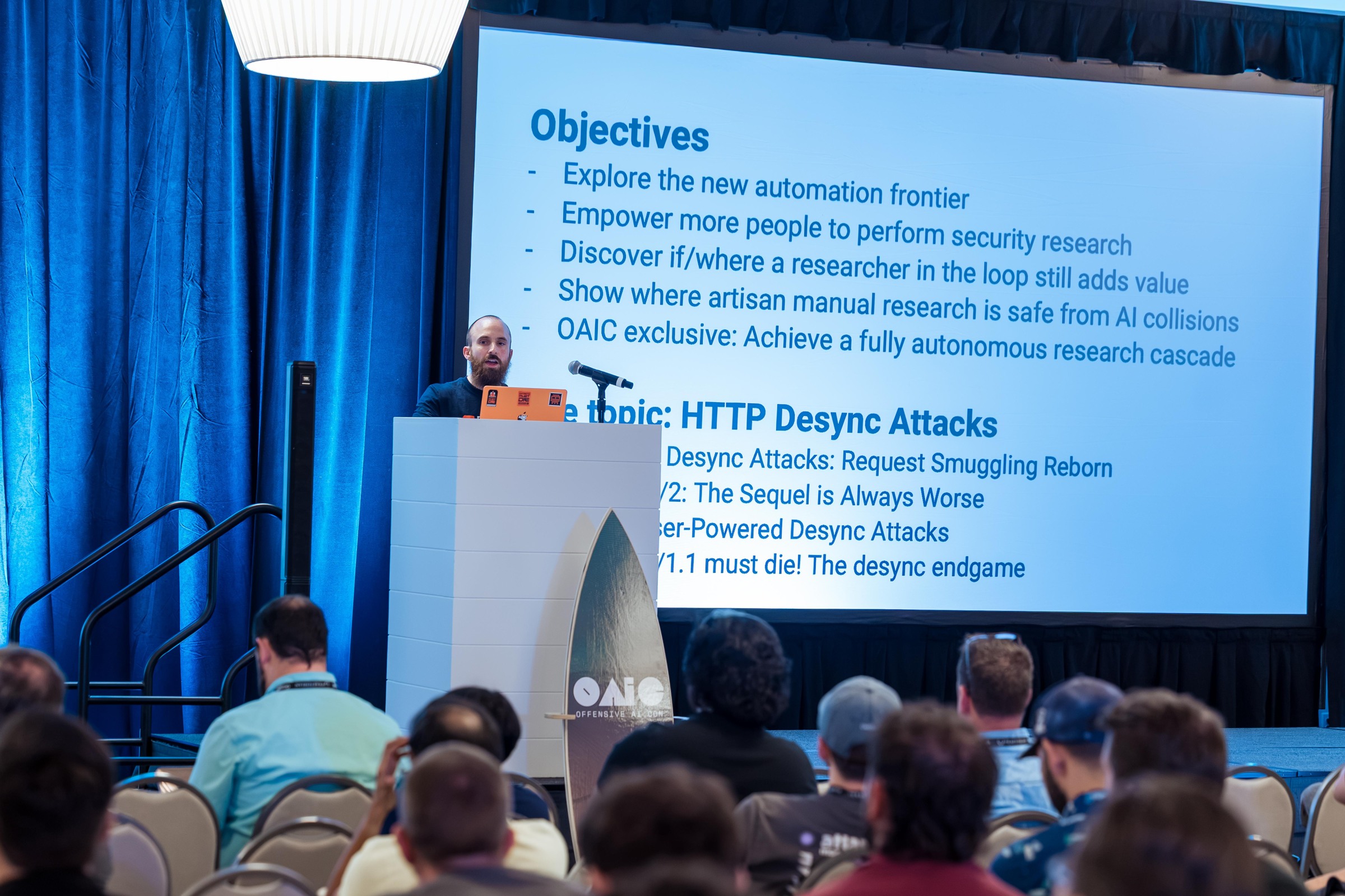 A researcher presenting The HTTP Terminator with the talk objectives projected behind.