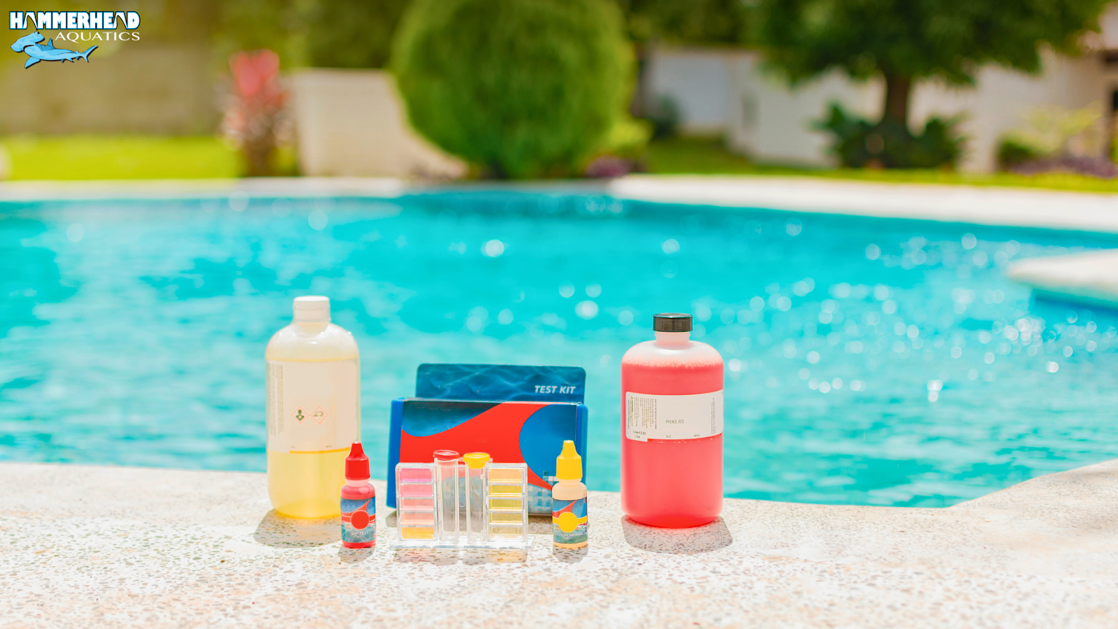 Pool water testing kit placed beside a crystal-clear swimming pool
