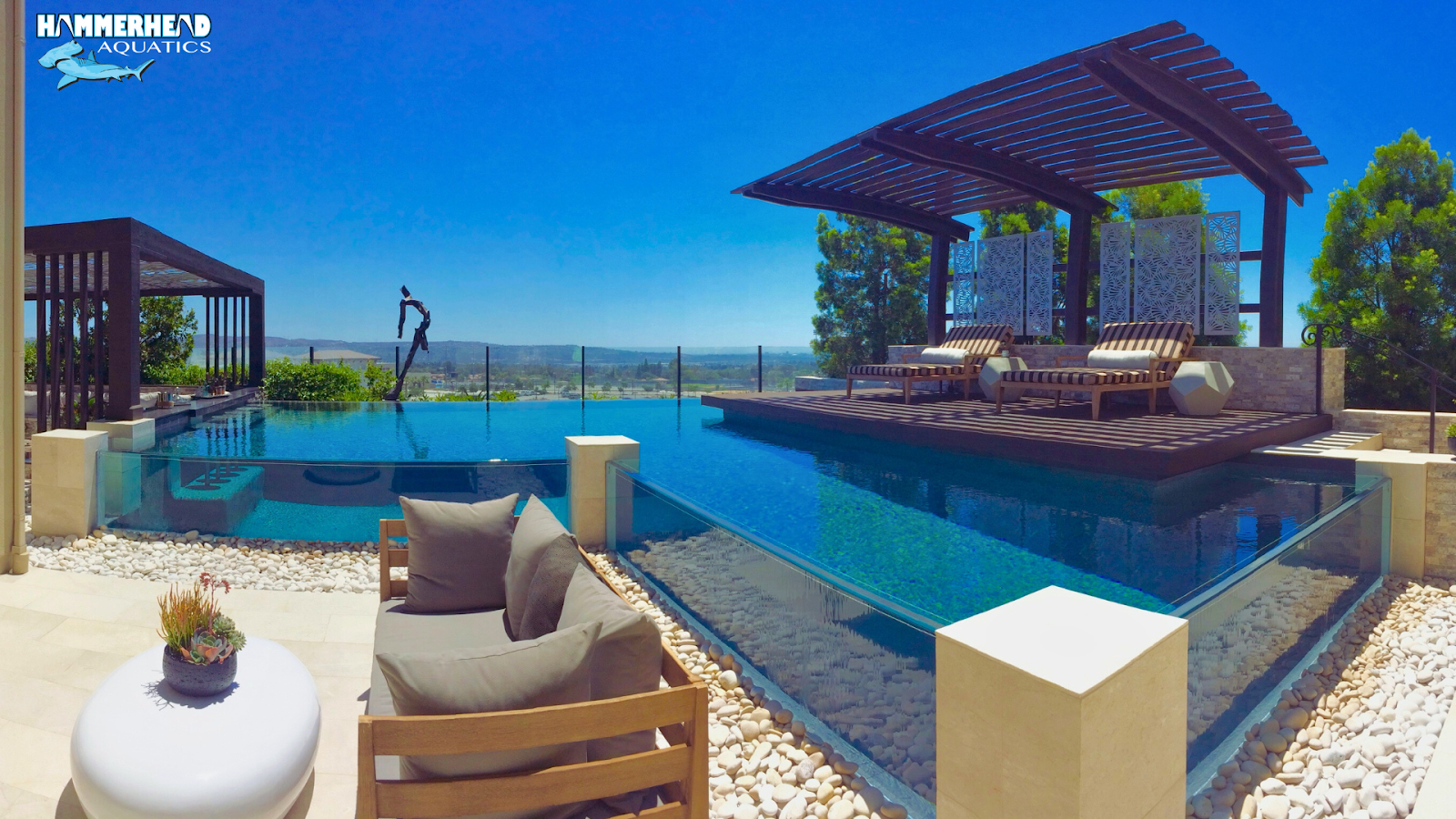 Creative pool design featuring curved acrylic window installation.