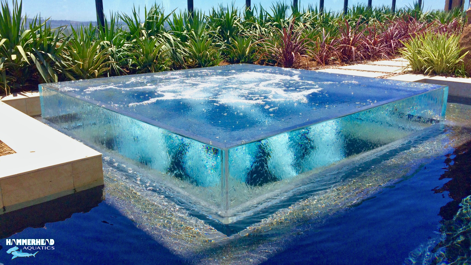 Frameless acrylic pool window offering seamless underwater view.