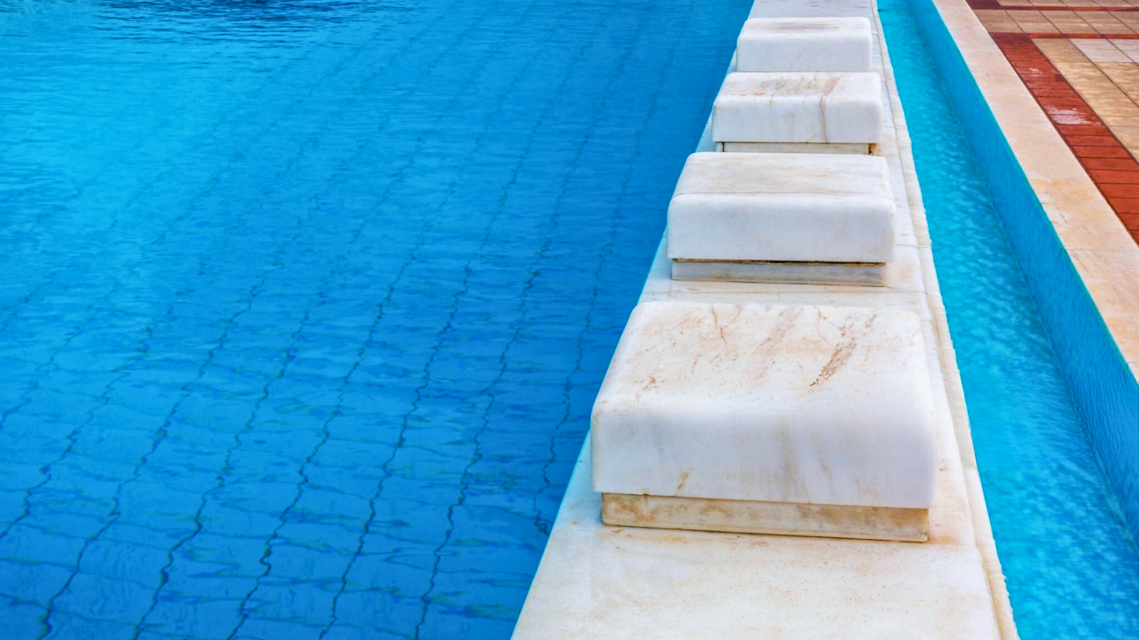 Polished marble coping around upscale resort pool