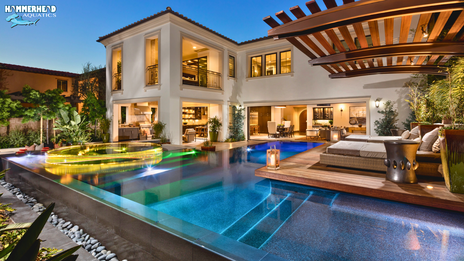 A luxury backyard pool with lounge chairs and landscaping, representing thoughtful pool planning