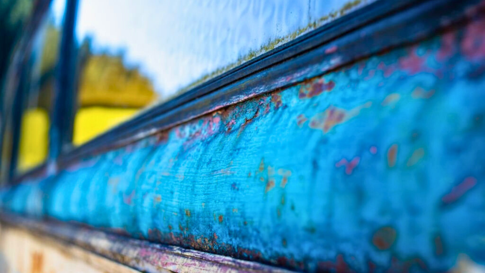Corroded metal frame of a pool window in humid environment