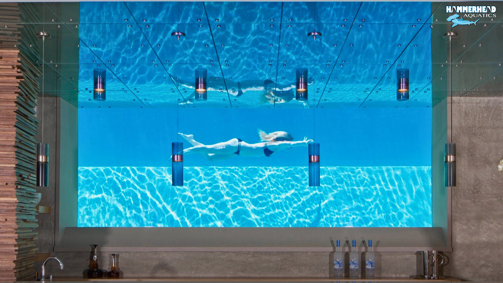Luxury swimming pool with large underwater glass window for viewing