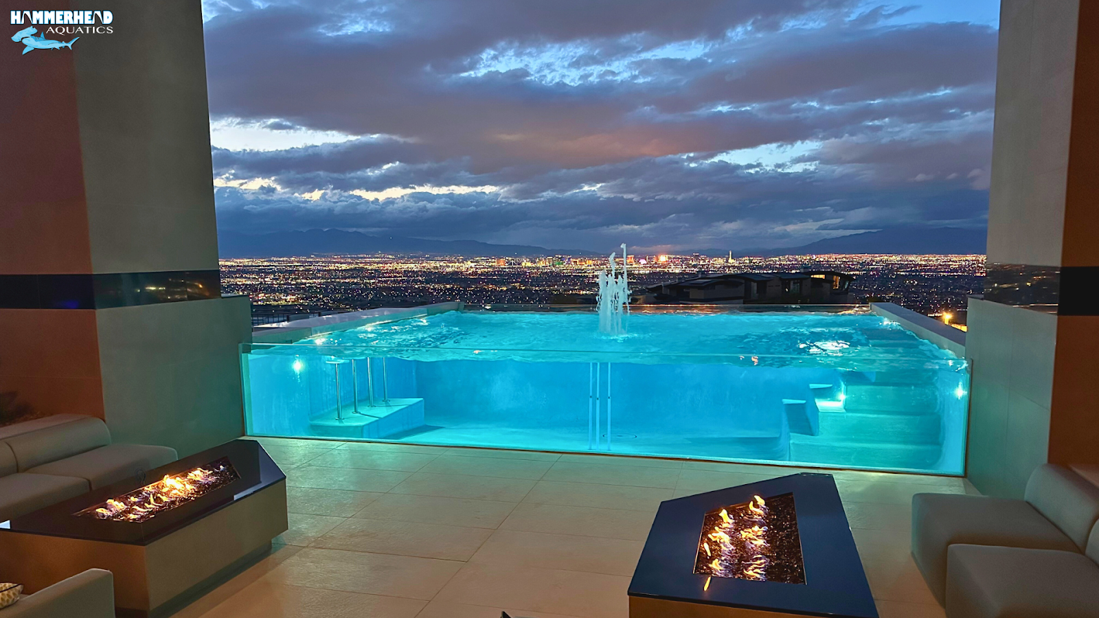 Infinity edge pool with acrylic viewing wall and dramatic skyline view