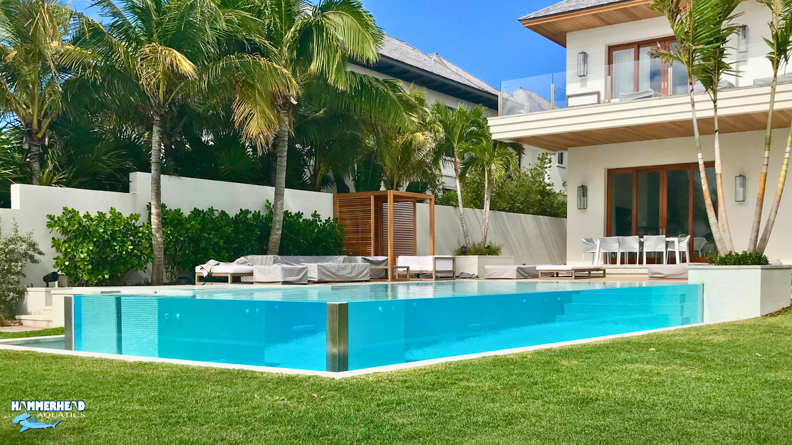 Resort-style backyard pool with cabanas and poolside entertainment