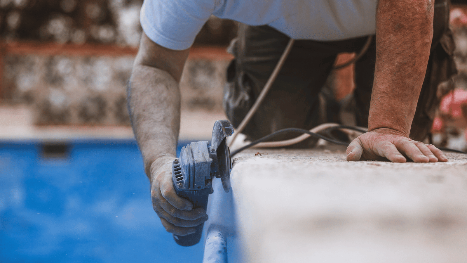 Gunite swimming pool surface being built with sprayed concrete over rebar framework.