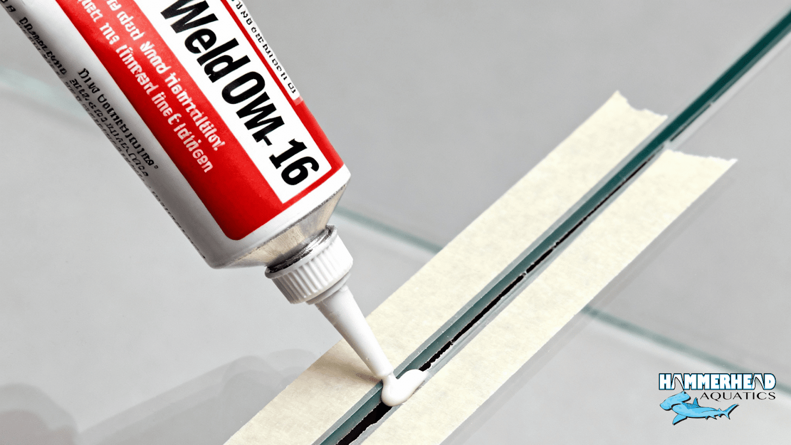 Applying thicker acrylic cement to fill small seam voids on aquarium window panel.