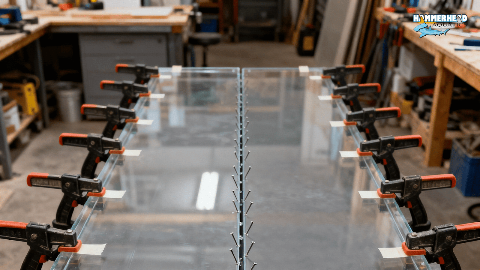 Clamping and pinning setup for acrylic bonding with markers for precise curing alignment.