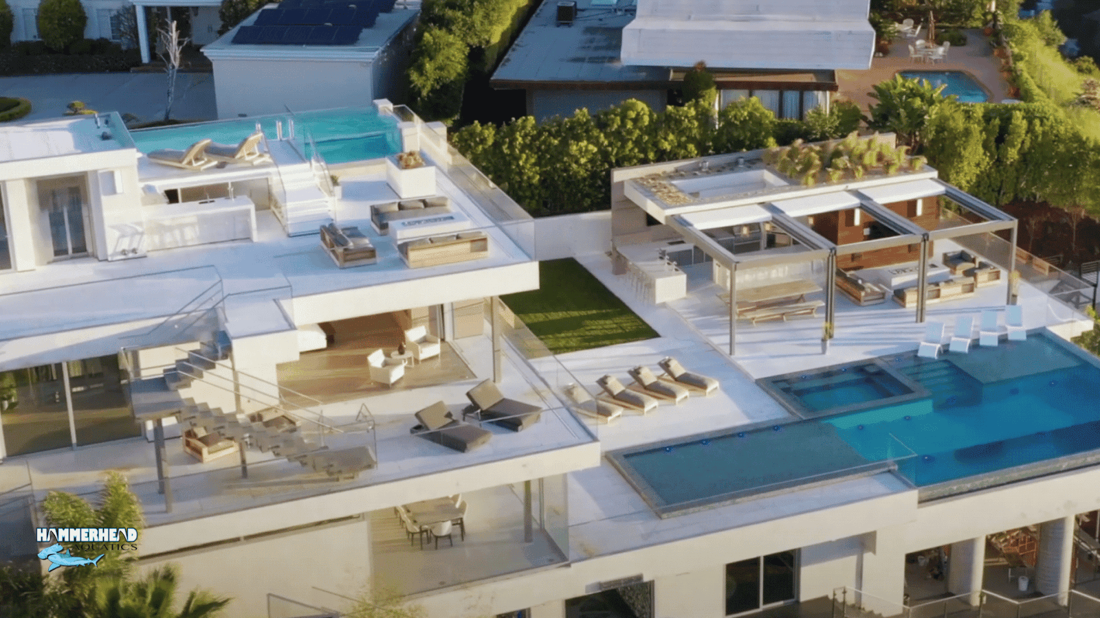 Luxury rooftop hotel pool with large acrylic underwater window overlooking city skyline