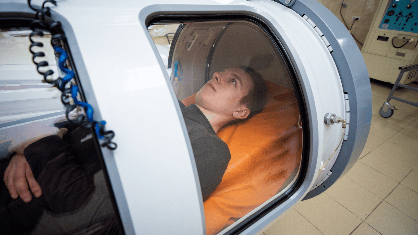 Hyperbaric oxygen chamber with thick acrylic underwater-style observation window.