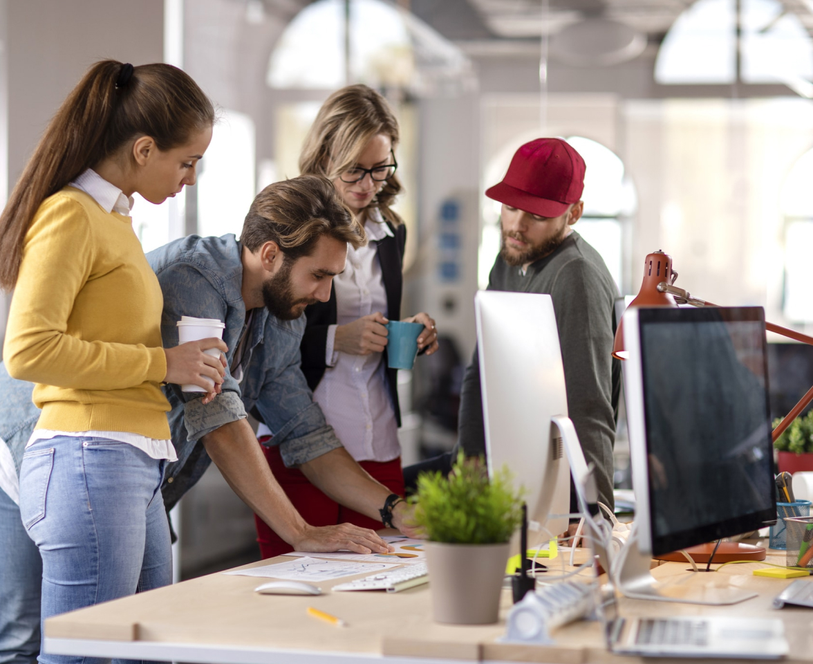 a group of people looking at a computer screen