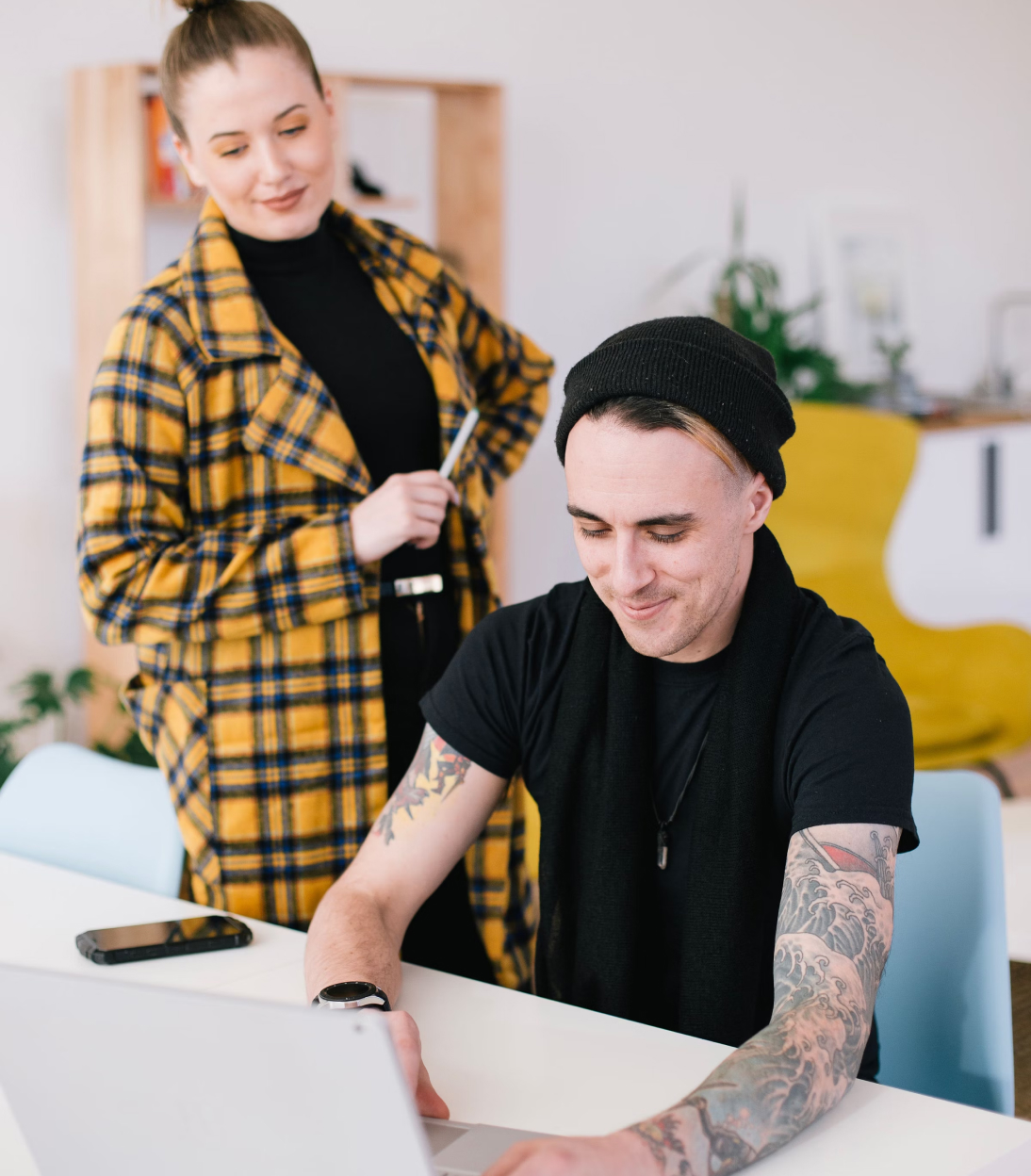 a man sitting at a table using a laptop computer