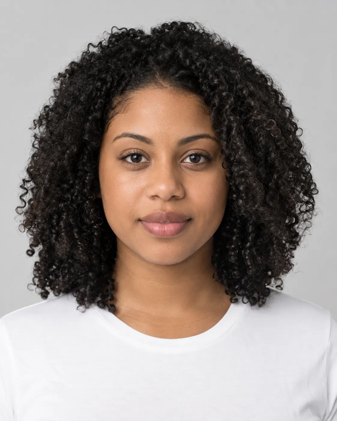 Woman with springy, defined type 4a coils worn loose, an example of hair suited to the Crown Ritual Head Spa