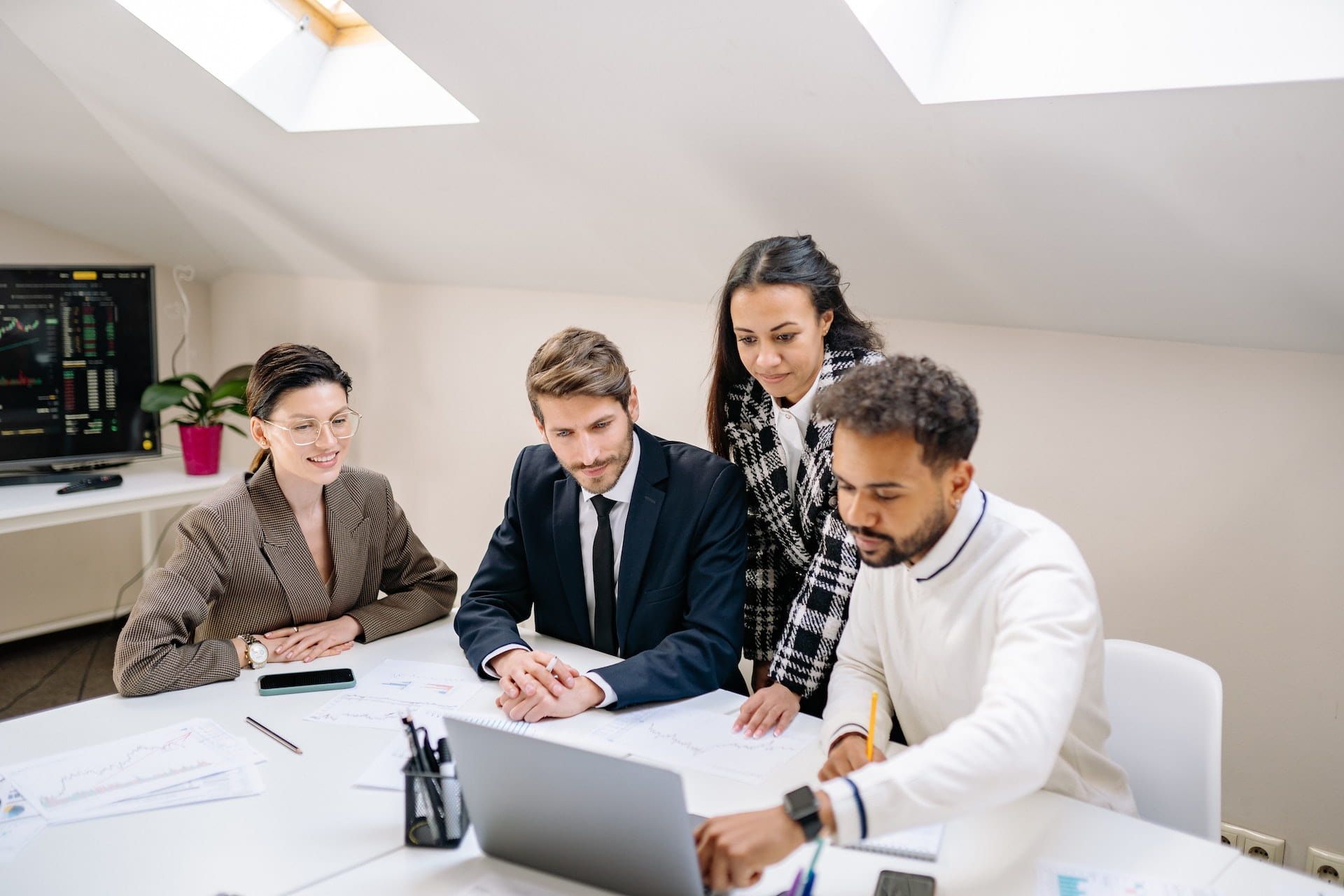 A team discussing at the table with a laptop