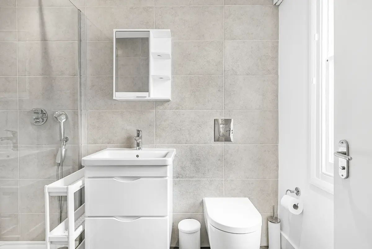En-suite bathroom with contemporary fittings and glass shower enclosure