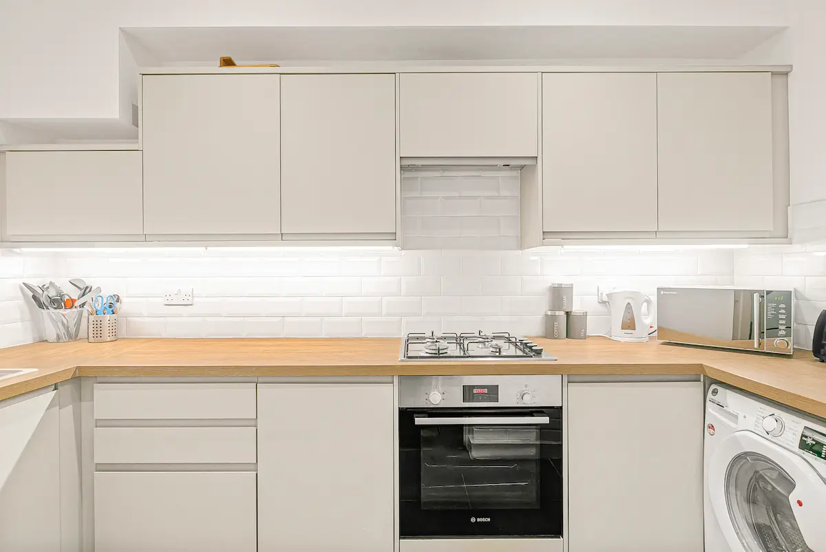 Fully equipped modern kitchen with integrated appliances and minimalist cabinetry