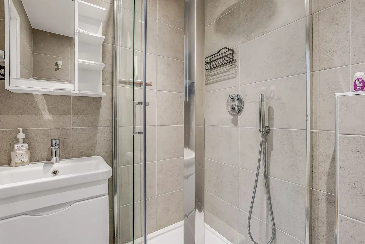 Luxury bathroom with marble-style tiles and high-end fixtures