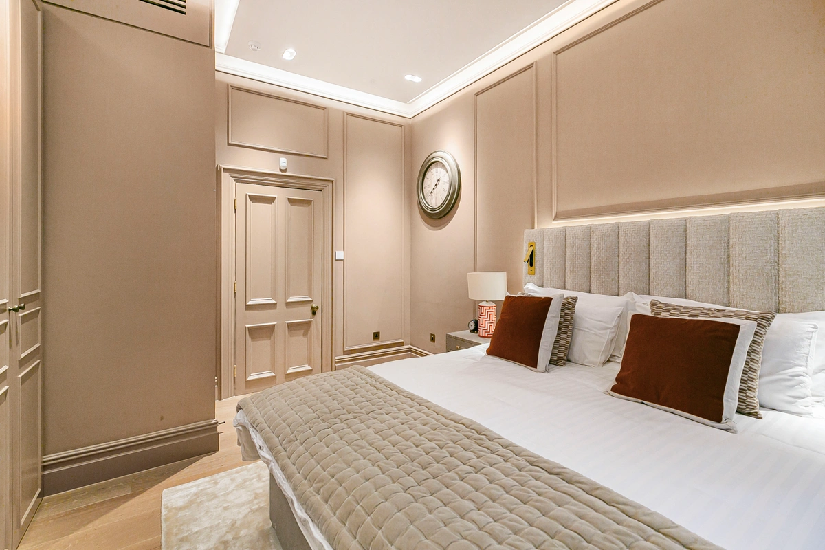 Bright and serene bedroom with large windows and refined furnishings