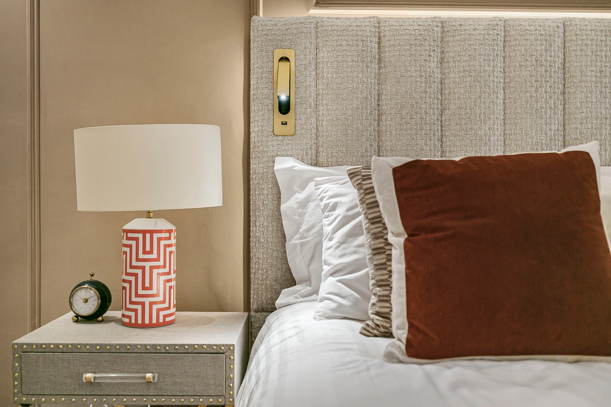 Close-up of a super king-sized bed with premium bedding and cushions