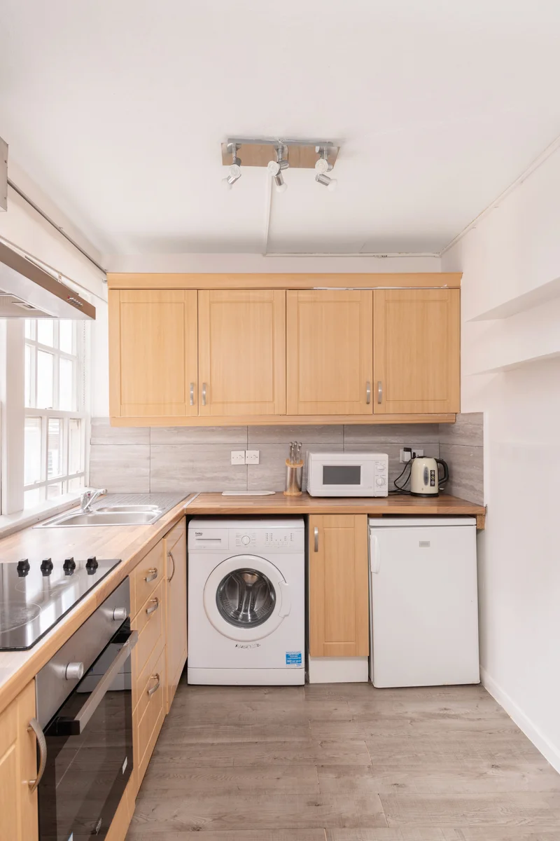 Functional and stylish kitchen featuring modern cabinetry and lighting
