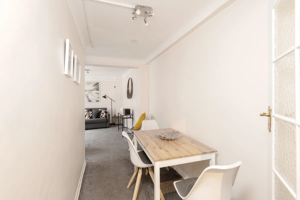 Dining area with a sleek table and comfortable seating for four