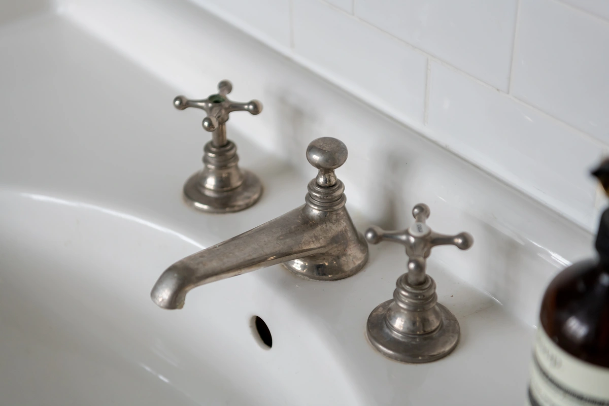 Detail of marble sink and elegant tap design
