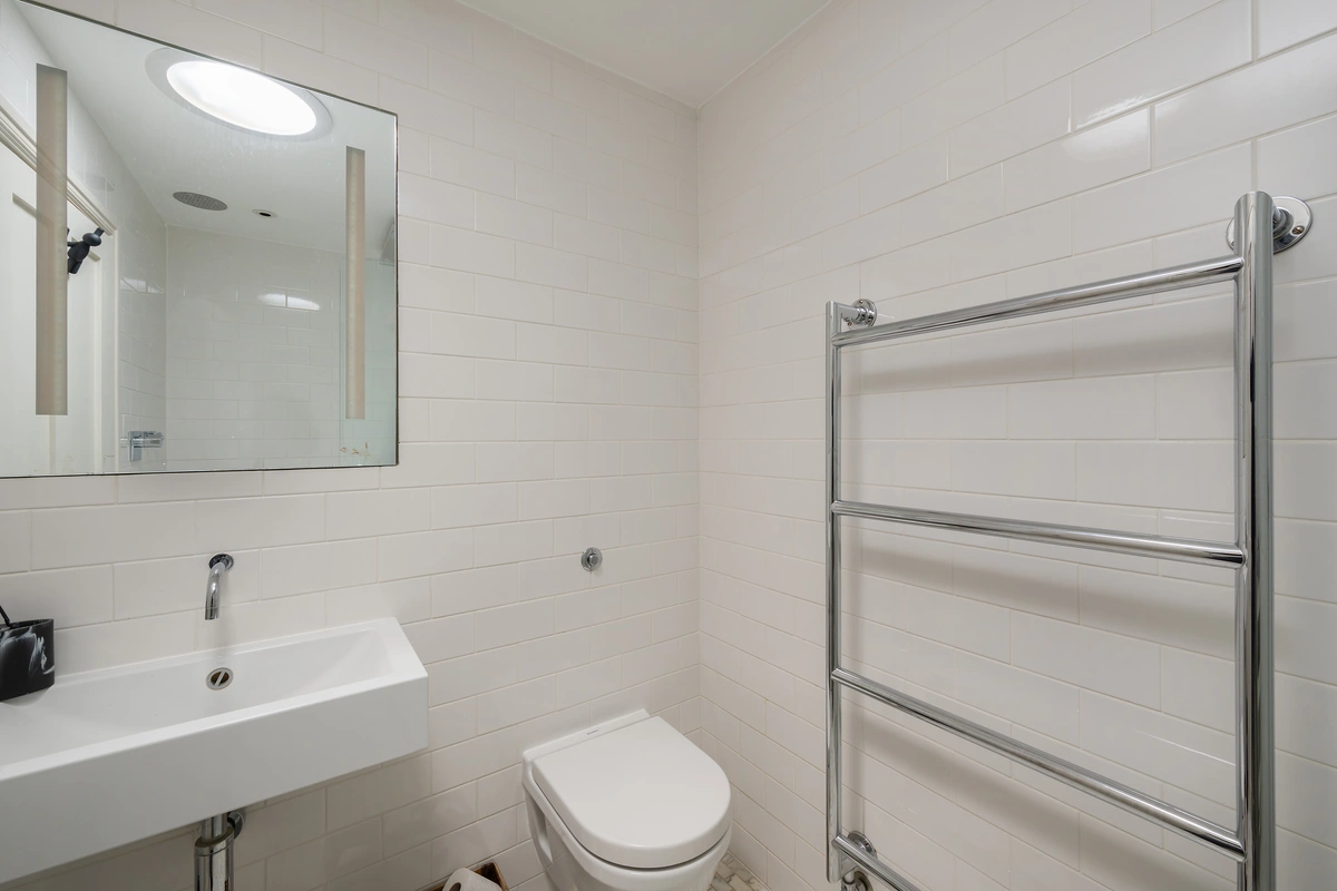 Stylish bathroom with marble tiles and refined fixtures