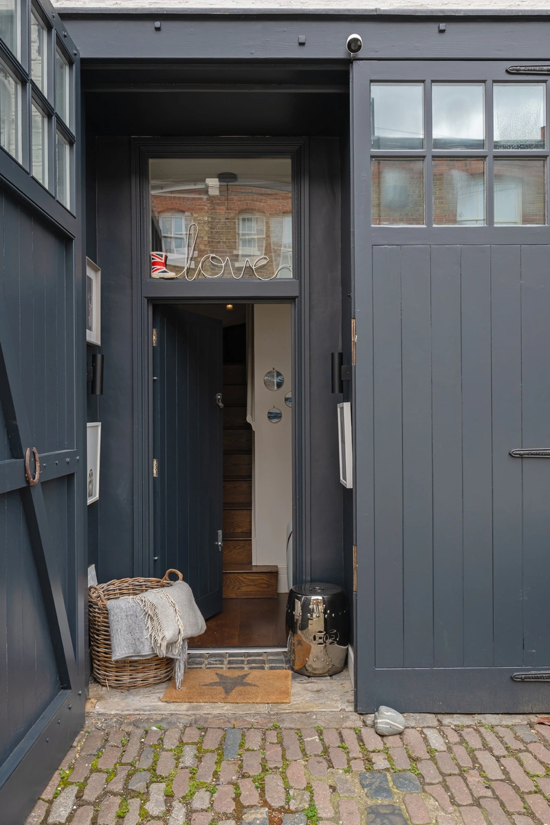 Entryway with cobblestone path and charming facade