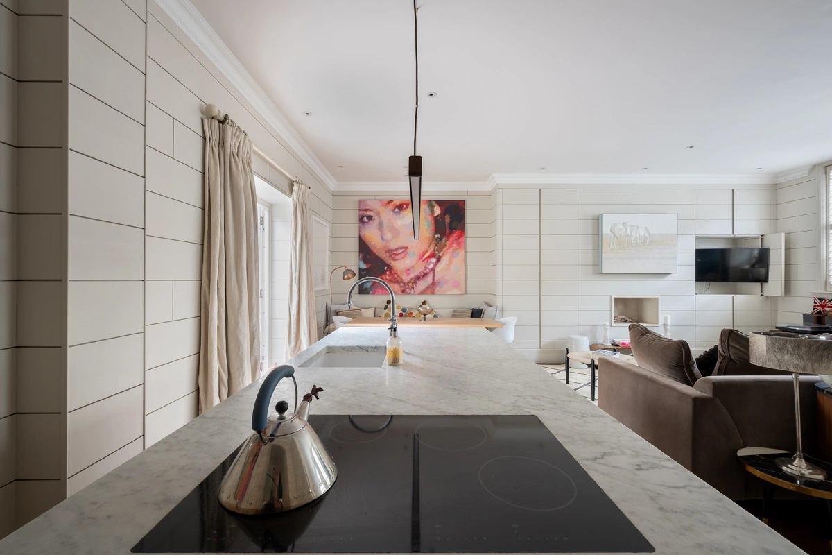 Open-concept kitchen with marble surfaces and ample storage