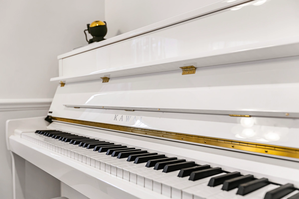 Side view of piano with a luxurious ambiance in the background
