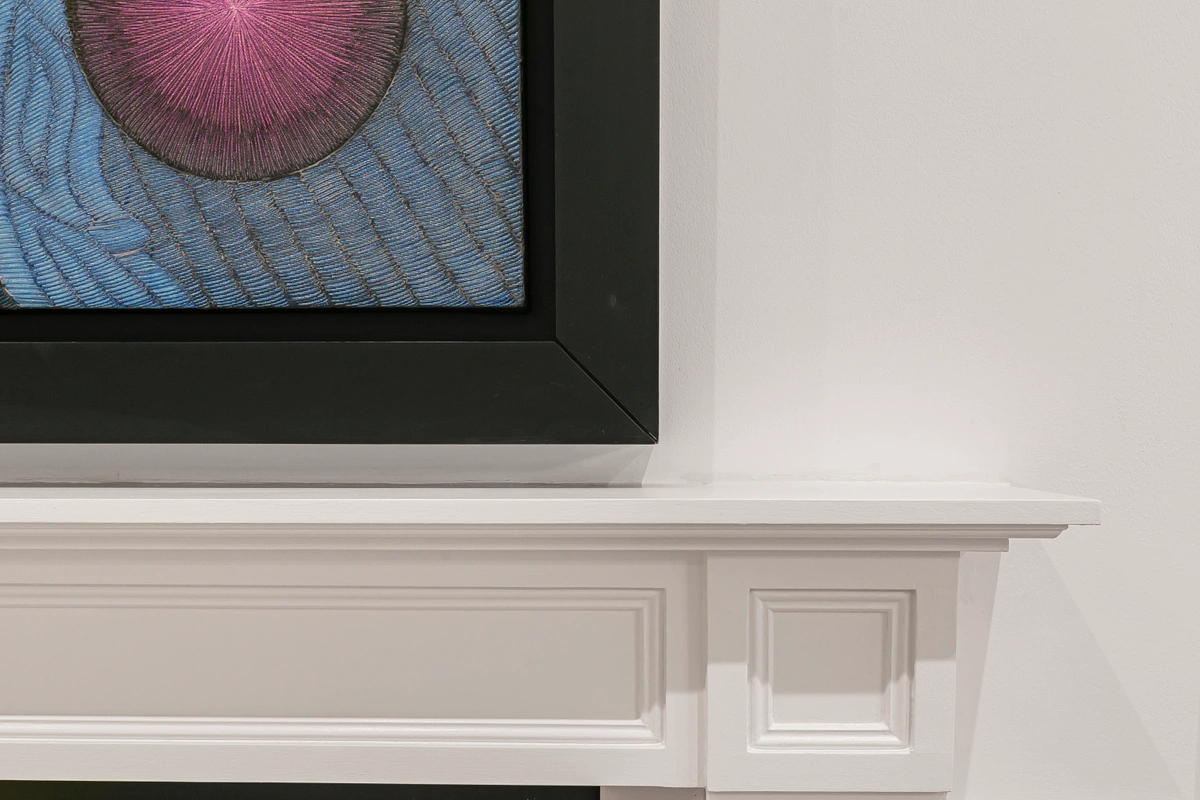 Close-up of floating shelves displaying artwork and stylish decor