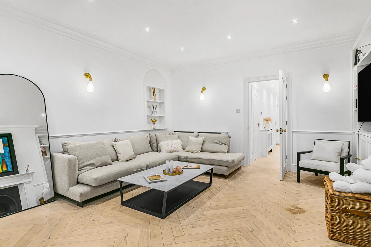 Second angle of living room showcasing the fireplace and elegant furnishings