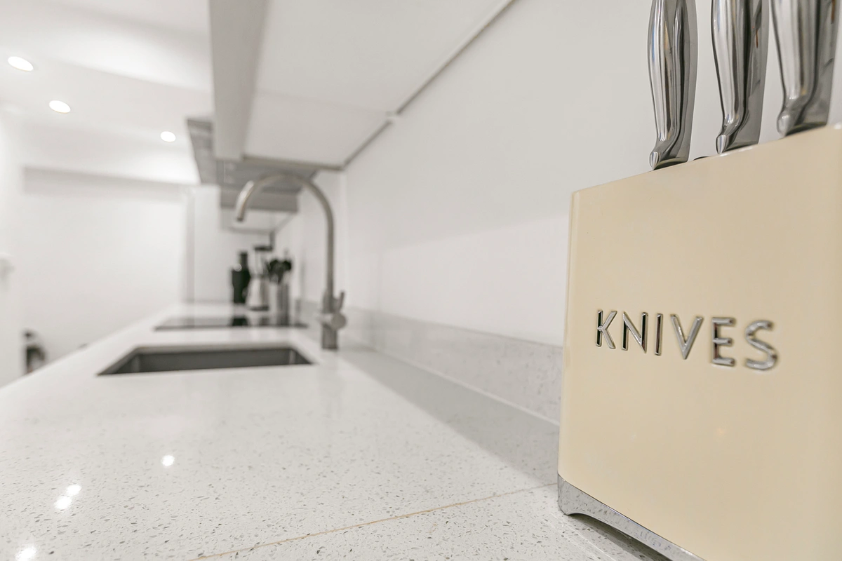 Detailed view of kitchen countertop with luxury utensils and sleek fittings