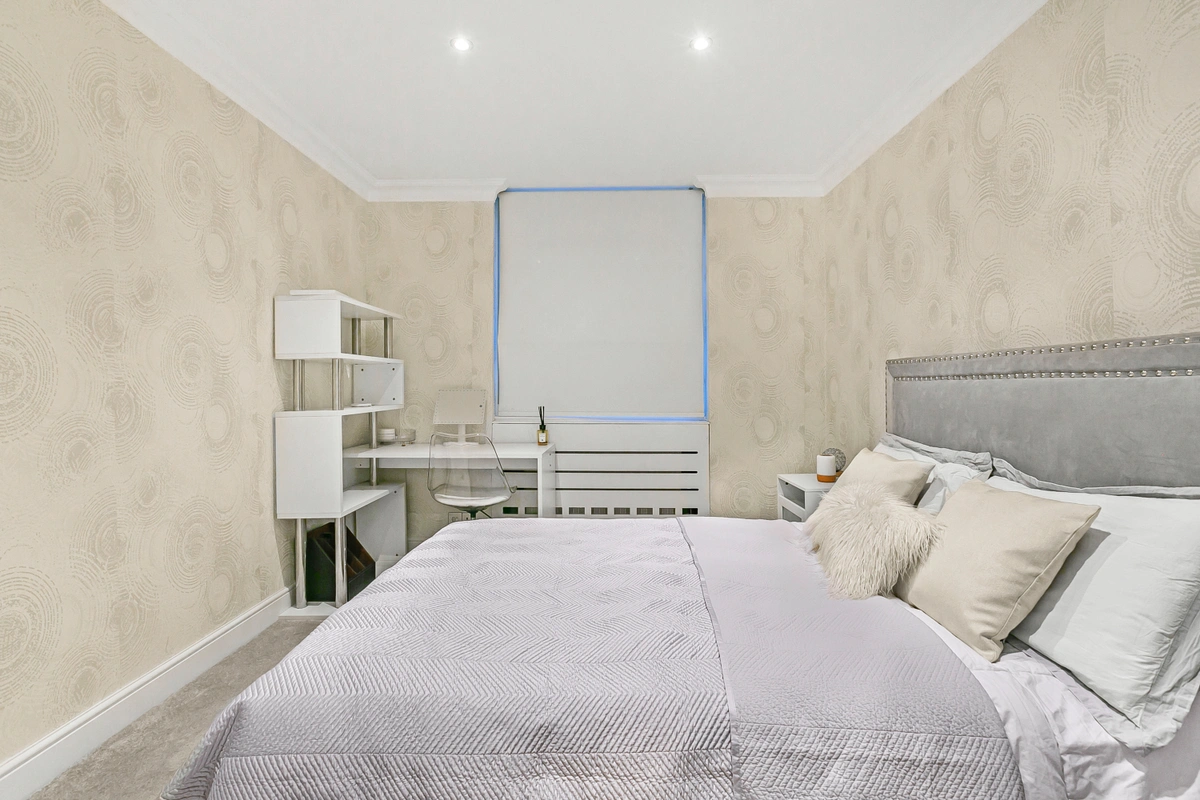 Double bed with luxurious bedding and soft lighting in the bedroom