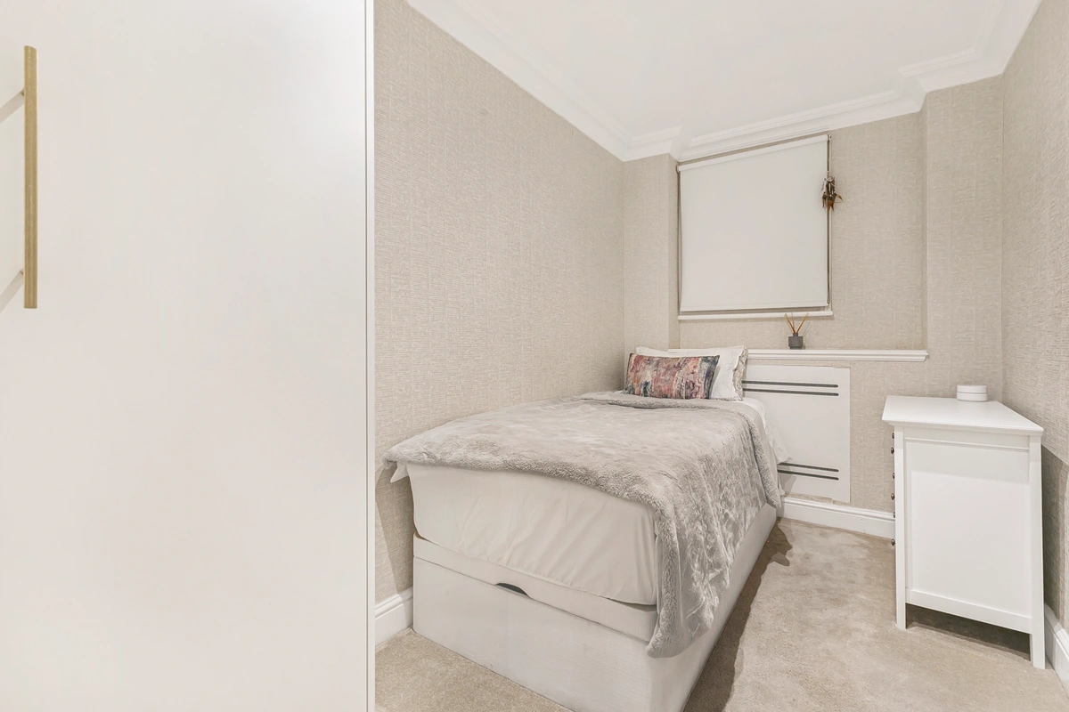 Single bed with minimalist decor and plush bedding