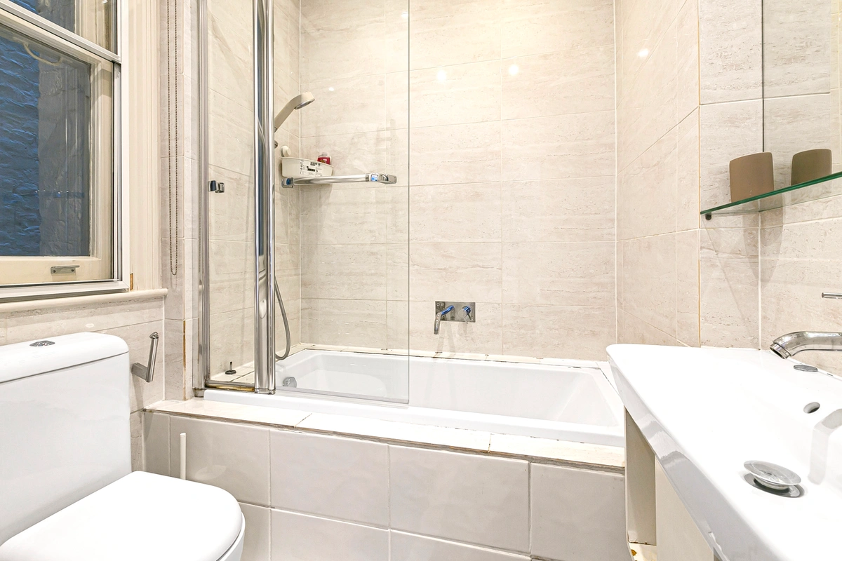 Luxurious bathroom with soaking tub and gold-accented fixtures