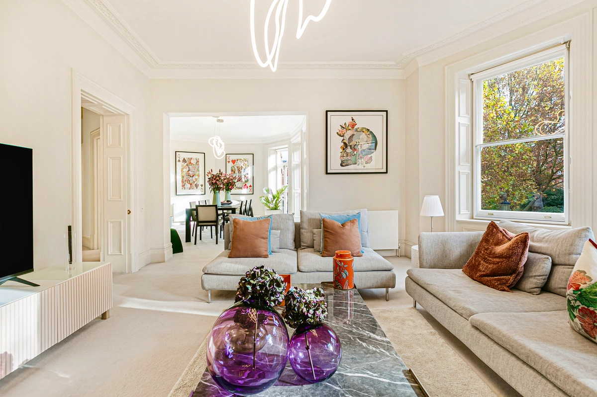 Living room with plush seating, fireplace, and stylish artwork