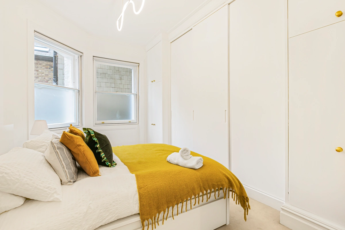 Cozy second bedroom featuring modern furnishings and soft tones