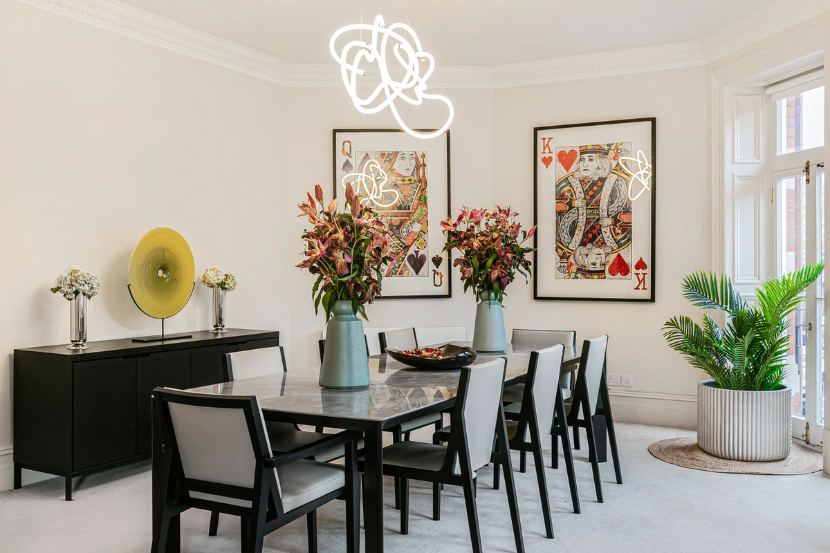 Formal dining room with statement chandelier and large table