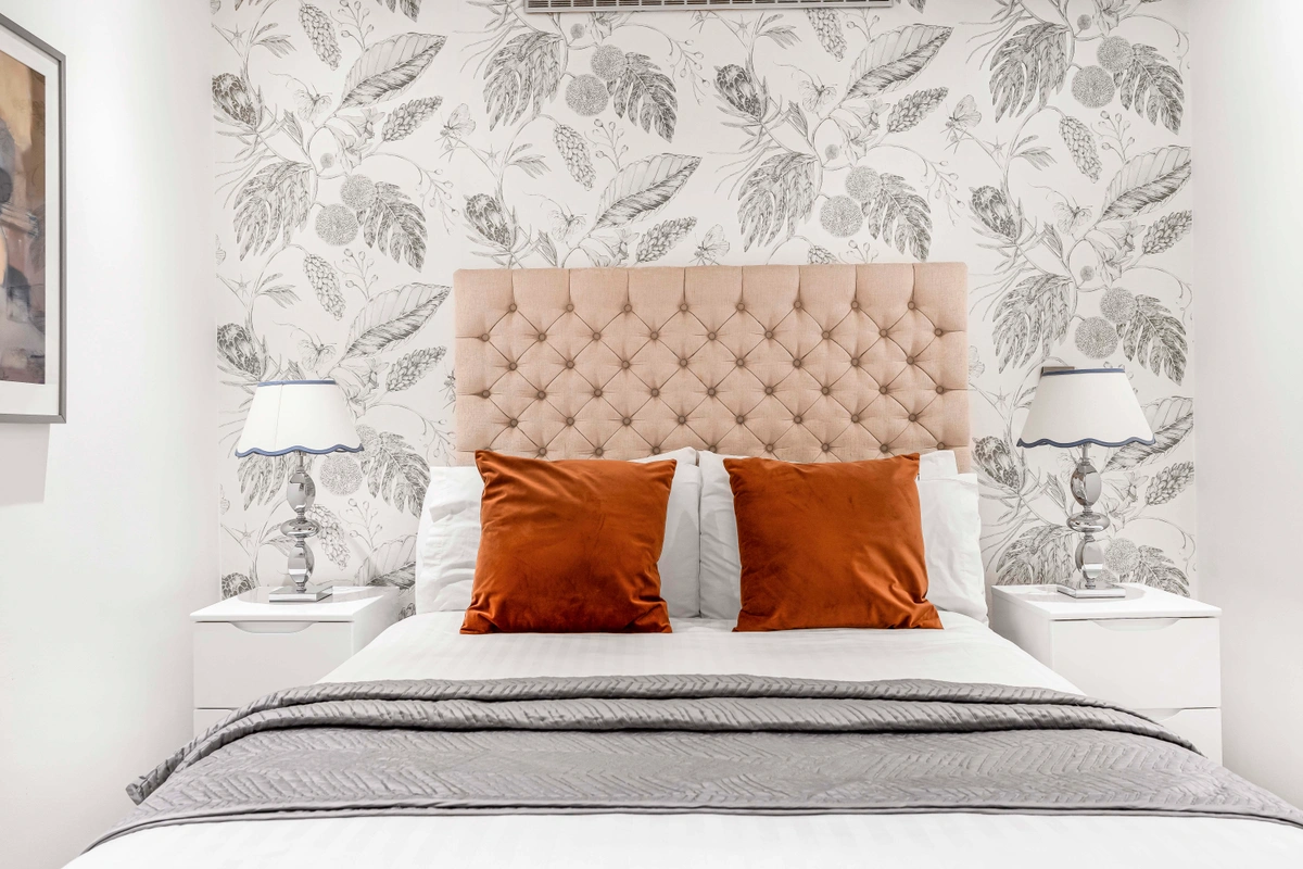 Close-up of a luxurious bed with layered textiles and soft pillows