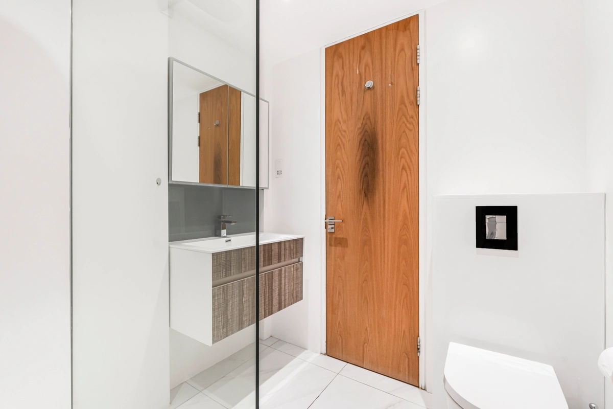Elegant bathroom with marble walls and a glass-enclosed shower